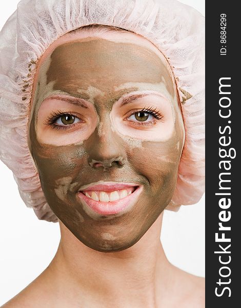 Young healthy woman with facial mask
