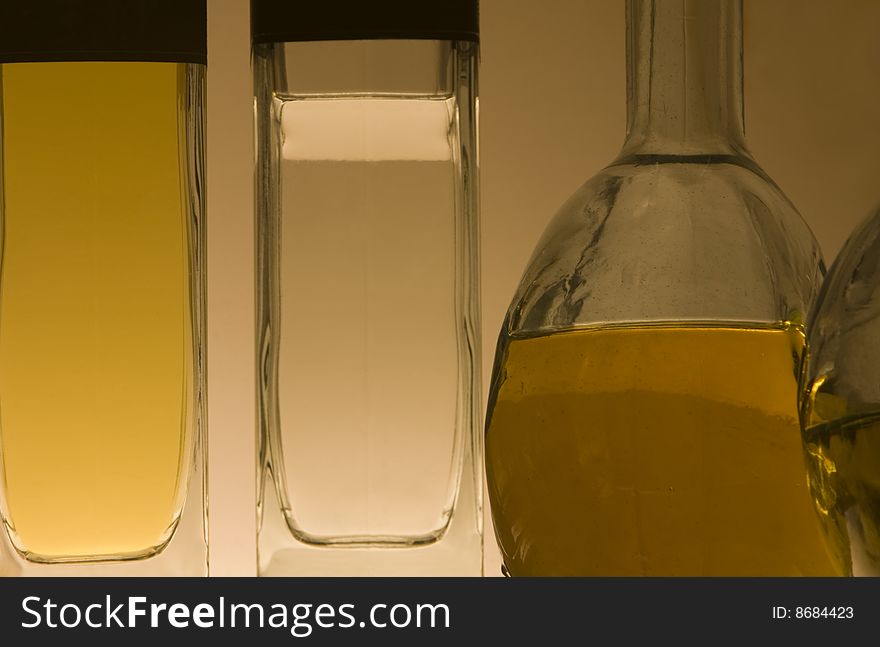 Four tequila bottles glow with soft light