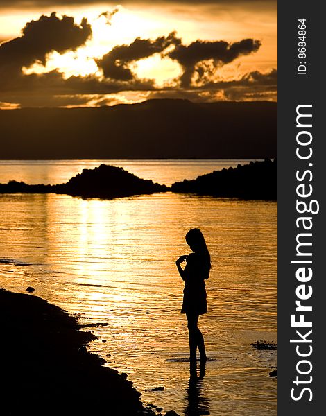 A girl stand in golden sunset