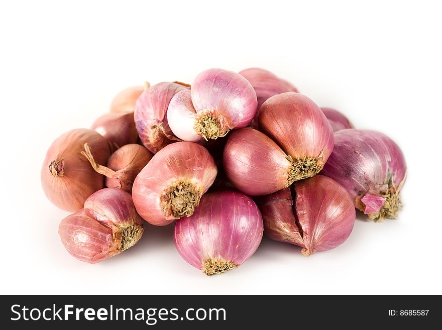 A heap of onions on white background