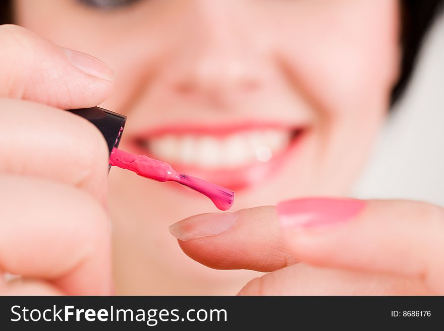 Woman applying red nail polish