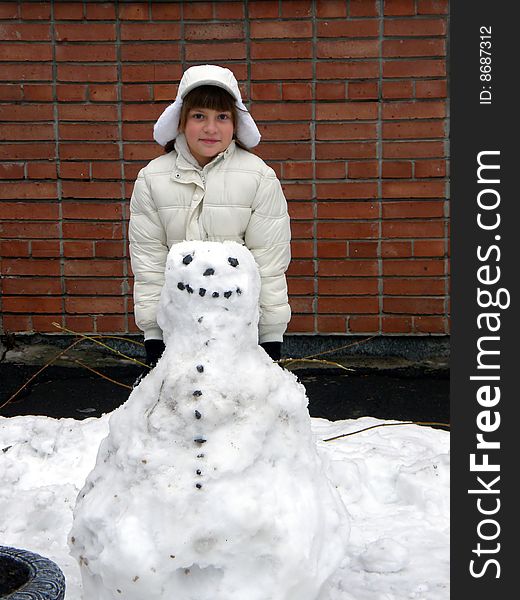 Smiling girl in white and snowman. Smiling girl in white and snowman