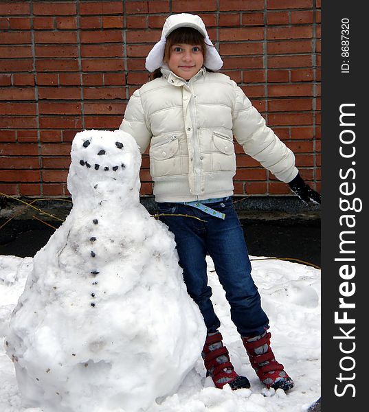 Smiling girl in white and snowman. Smiling girl in white and snowman