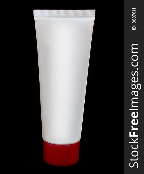White tube with red top on black