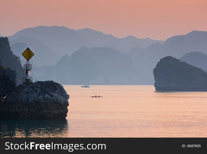 Leading light, boat and islands in Ha Long Bay, Northern Vietnam