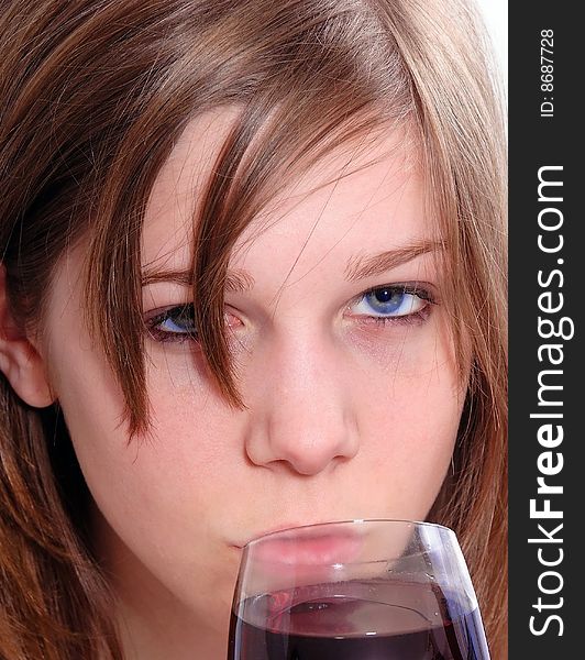 Brunette Woman in a purple shirt drinking red wine, isolated on white background. Brunette Woman in a purple shirt drinking red wine, isolated on white background