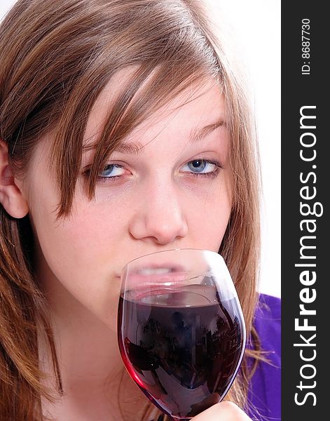 Brunette Woman in a purple shirt drinking red wine, isolated on white background. Brunette Woman in a purple shirt drinking red wine, isolated on white background