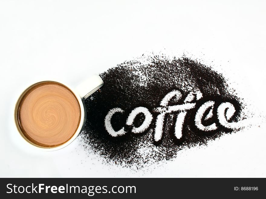 Coffee with milk in the big cup with an inscription on a table