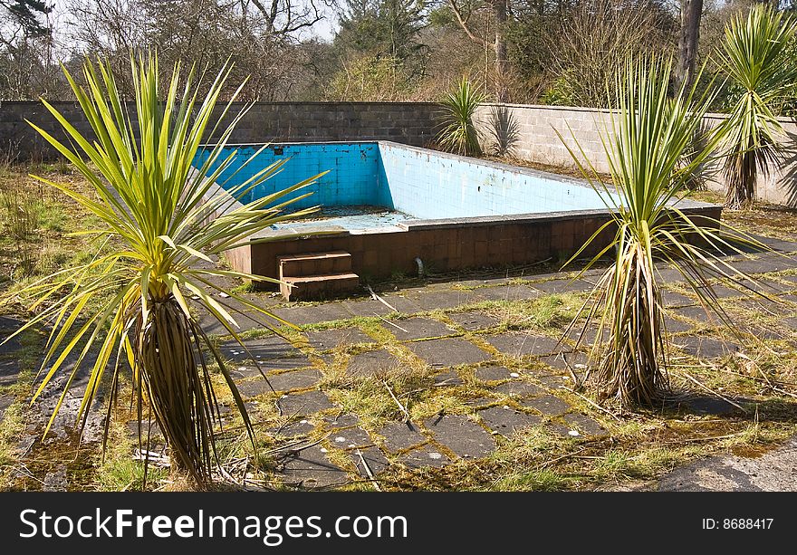 Old derelict swimming pool that has laid unused for many years