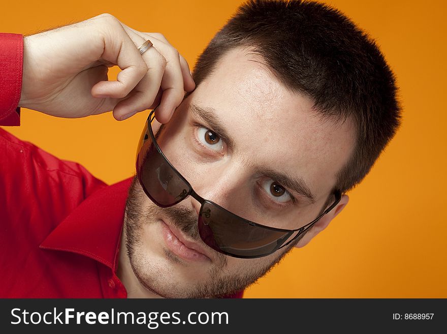 Man Looking Over His Sunglasses On Orange