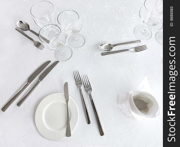 Knife, fork, spoon, plate and glases on a table. Knife, fork, spoon, plate and glases on a table