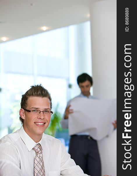 Confident young business man looking at camera.