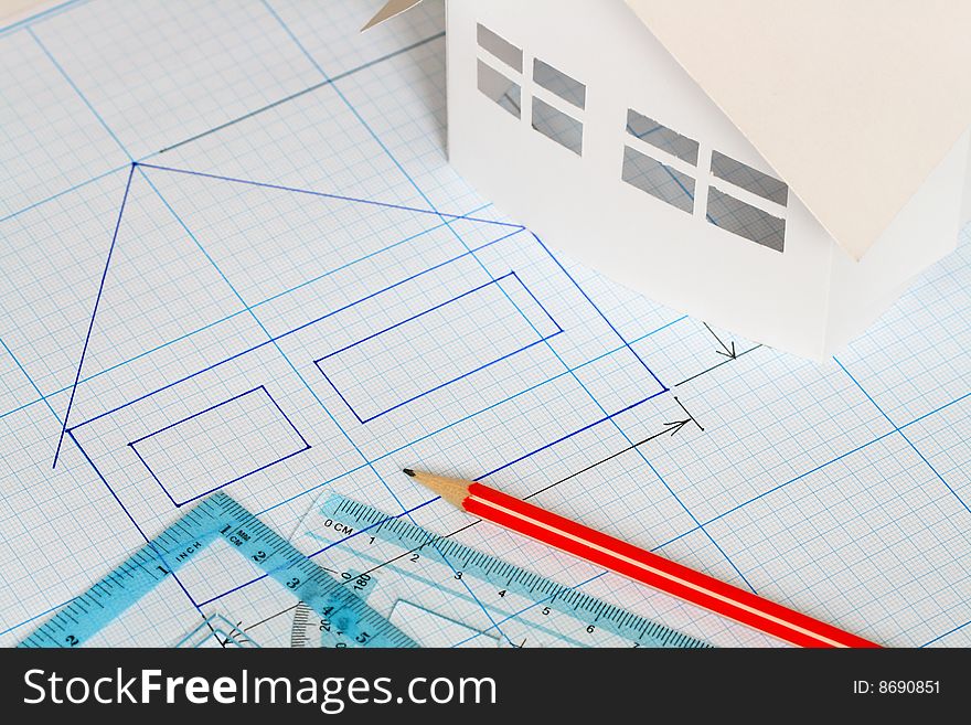 Drawing tools and little house on graph paper background. Drawing tools and little house on graph paper background