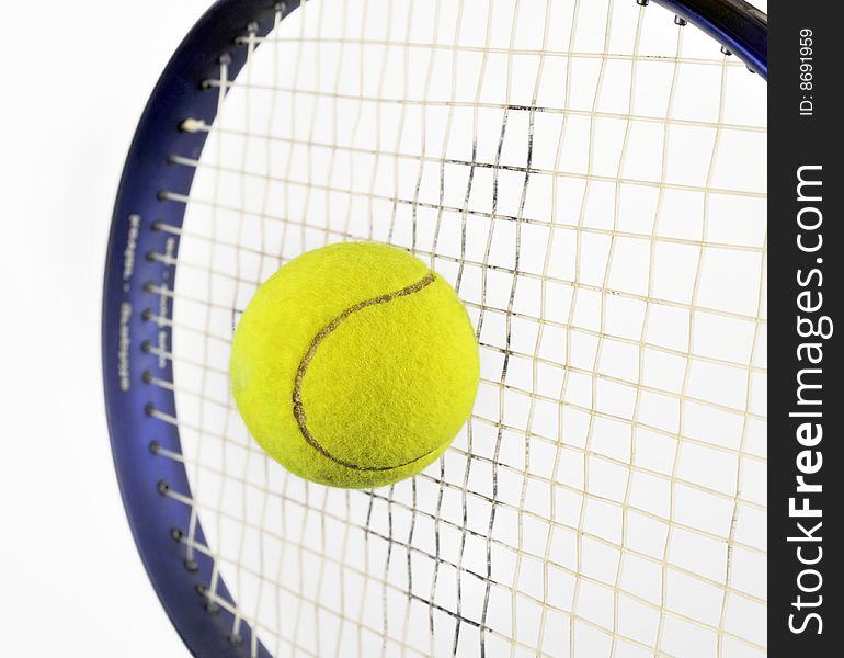 Tennis ball and racquet isolated on white