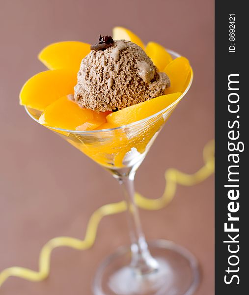 Close-up of a glass filled with peaches and ice-cream. Close-up of a glass filled with peaches and ice-cream