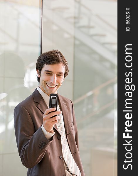 Portrait of confident smiling business man holding cell phone. Portrait of confident smiling business man holding cell phone.