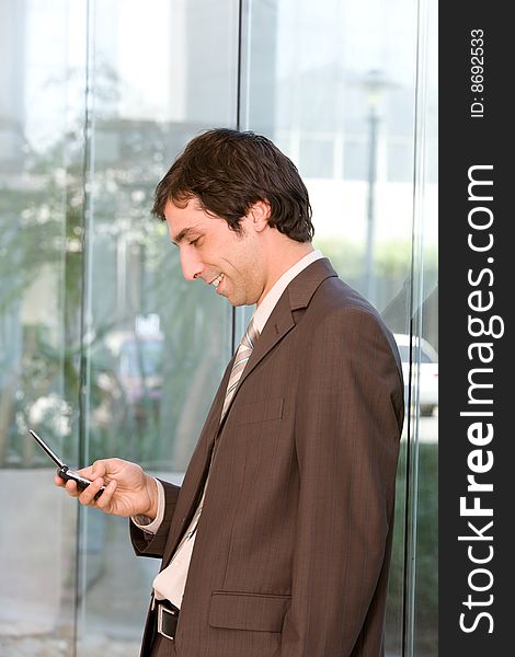 Portrait of confident smiling business man holding cell phone. Portrait of confident smiling business man holding cell phone.