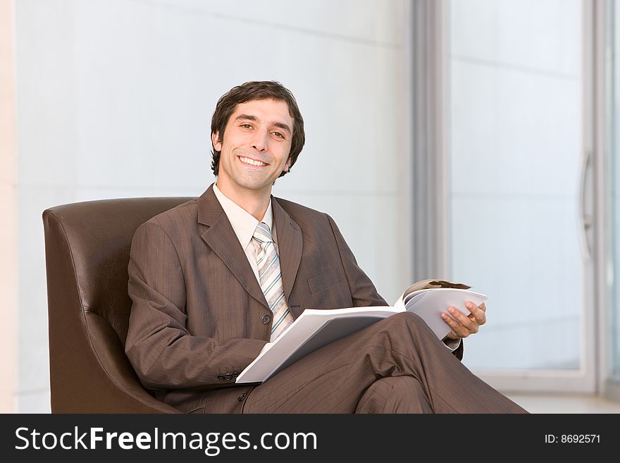 Smiling business man reading document. Smiling business man reading document.