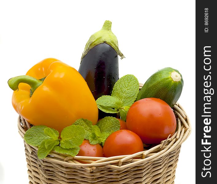 Basket with pepper, eggplant and tomatoes isolated on a white background. Basket with pepper, eggplant and tomatoes isolated on a white background