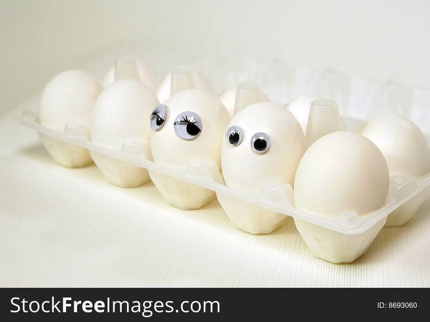 Two eggs with eye sit in packing on kitchen. Two eggs with eye sit in packing on kitchen