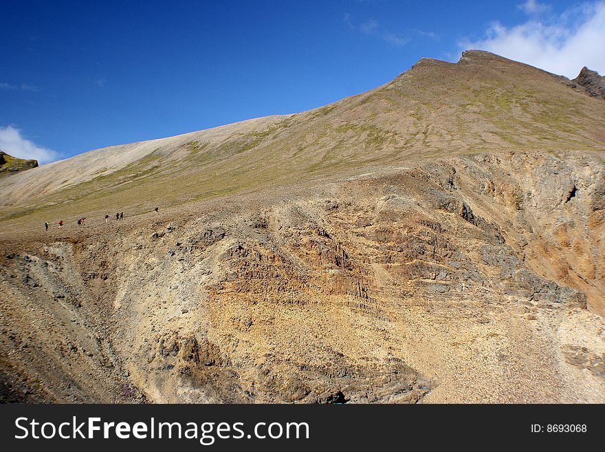 Trekkers Walking Up The Massive Mountain