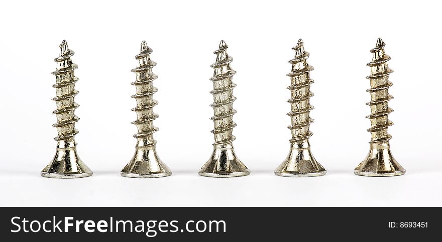 Metal screws in a row on a white background. Metal screws in a row on a white background