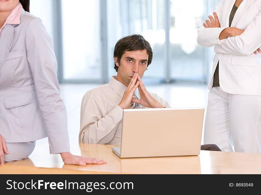 Confident business man working on laptop.