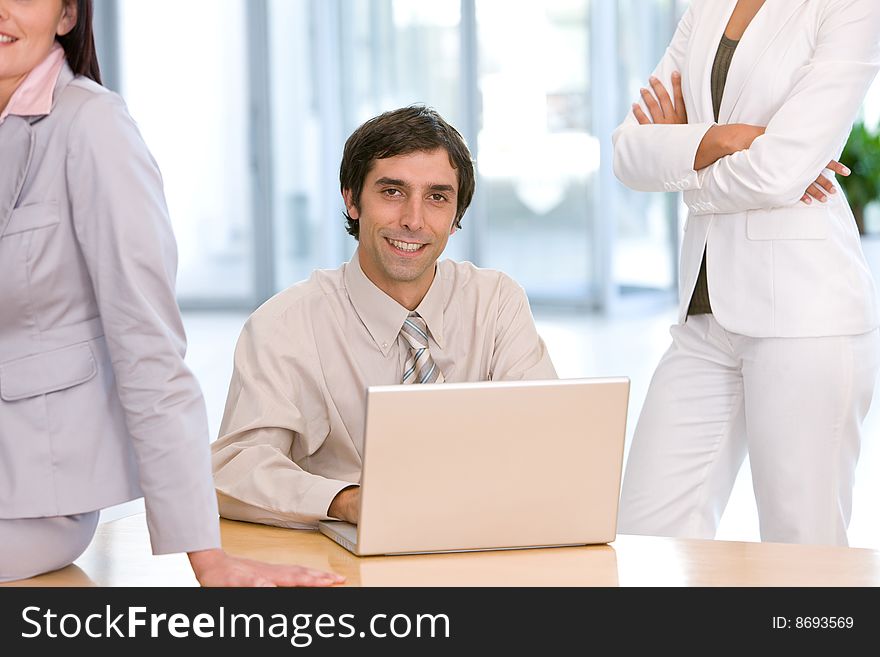 Confident business man working on laptop.