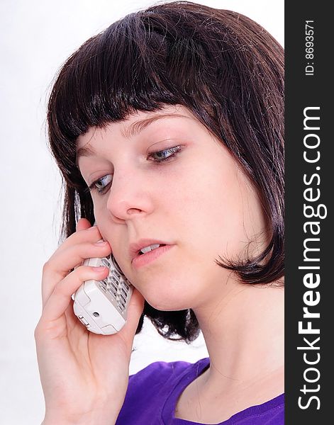 Studio shot of a beautiful brunette woman communicating on the telephone. Studio shot of a beautiful brunette woman communicating on the telephone