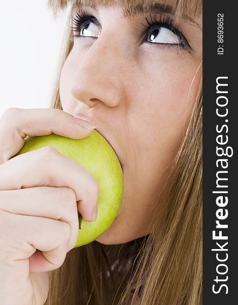 Young blue eyes girl with green apple. Young blue eyes girl with green apple.