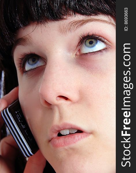 Studio shot of a beautiful brunette woman communicating on the telephone. Studio shot of a beautiful brunette woman communicating on the telephone