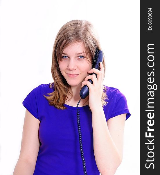 Studio shot of a beautiful brunette woman communicating on the telephone. Studio shot of a beautiful brunette woman communicating on the telephone