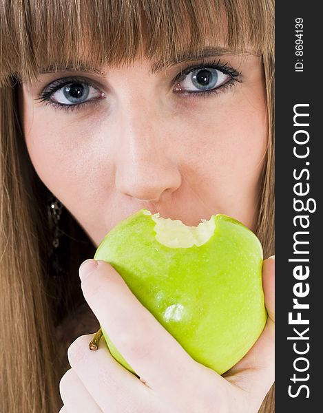 Young blue eyes girl with green apple. Young blue eyes girl with green apple.