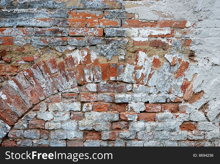 Fragment of tumbledown plastered brick wall. Fragment of tumbledown plastered brick wall