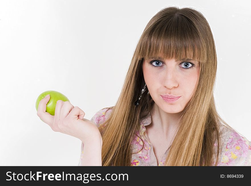 Young blue eyes girl with green apple. Young blue eyes girl with green apple.