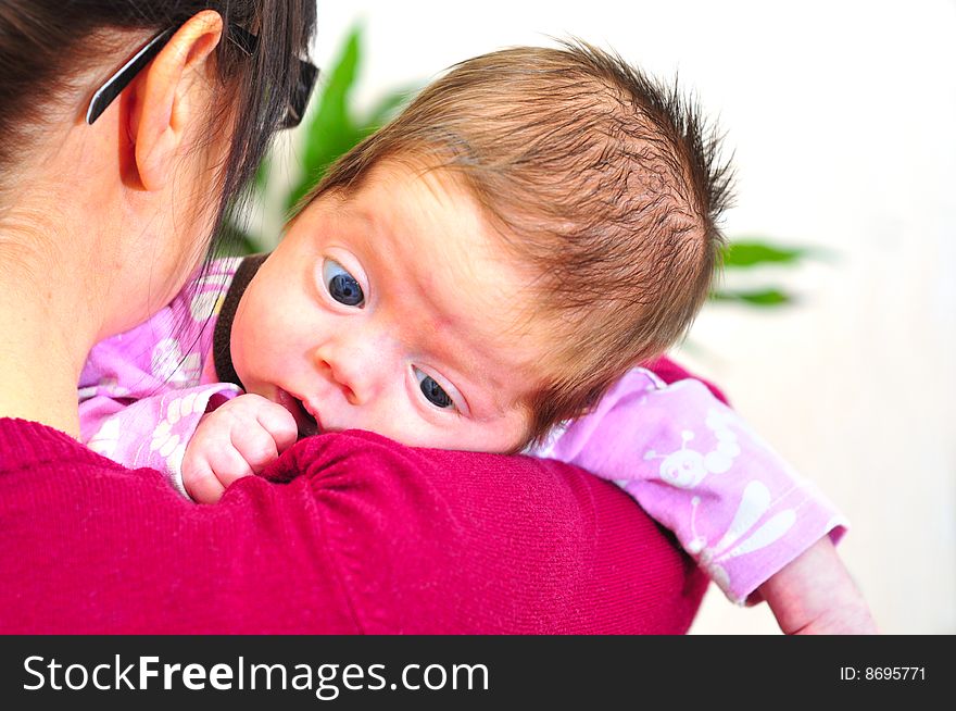 Baby girl on mothers shoulder. Baby girl on mothers shoulder