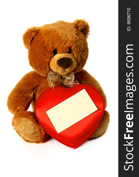 Teddy bear with box of sweets in the shape of heart and a card for the invitation. Teddy bear with box of sweets in the shape of heart and a card for the invitation.