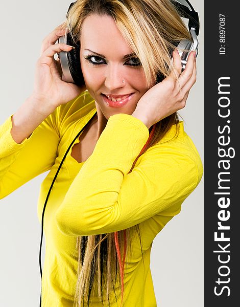 Attractive young girl with headphones over white background. Attractive young girl with headphones over white background