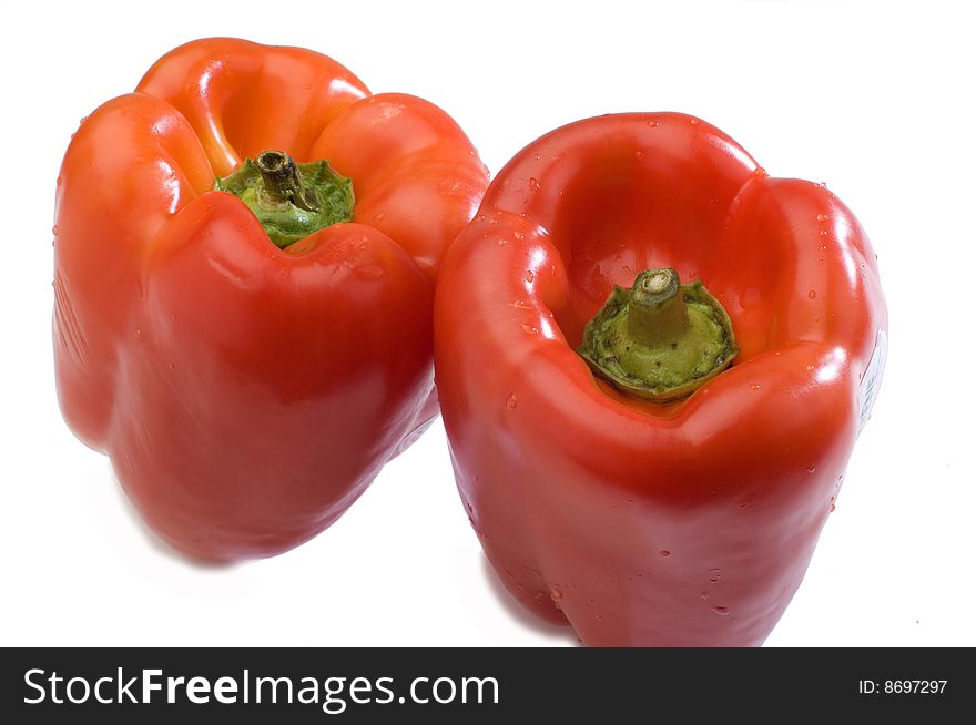 Two red peppers on a white background