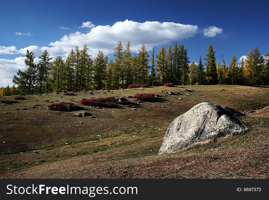 Autumn landscape, blue sky with white clouds and pasture, rock. Autumn landscape, blue sky with white clouds and pasture, rock.