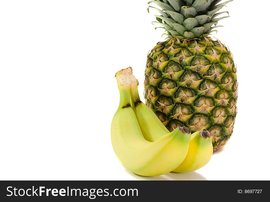 A pine apple and a banana on a white background(with copy space). A pine apple and a banana on a white background(with copy space)