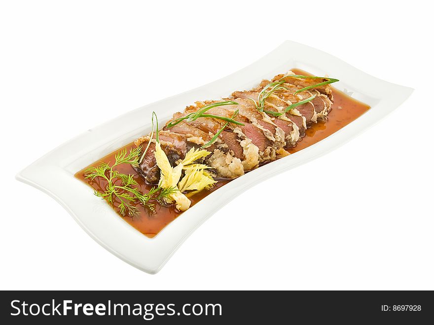 Plate with crisp duck on white background