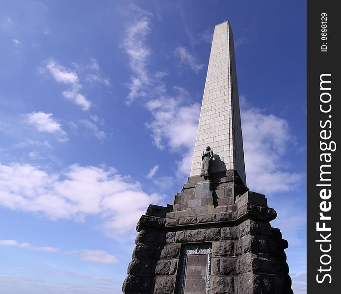 Photo of a monument with blue sky and clouds in the background. Photo of a monument with blue sky and clouds in the background.