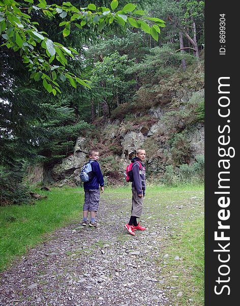 Two boys walking up hillside. Two boys walking up hillside.