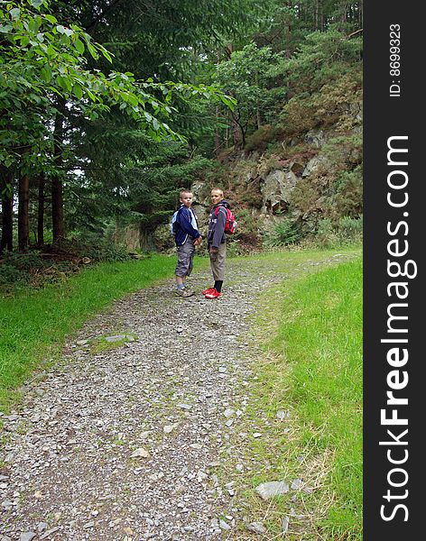 Boys walking up hillside in Lake District. Boys walking up hillside in Lake District.