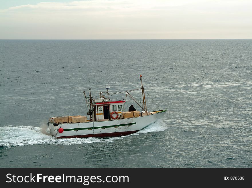 Fisherman in the boat goes fishing. Fisherman in the boat goes fishing