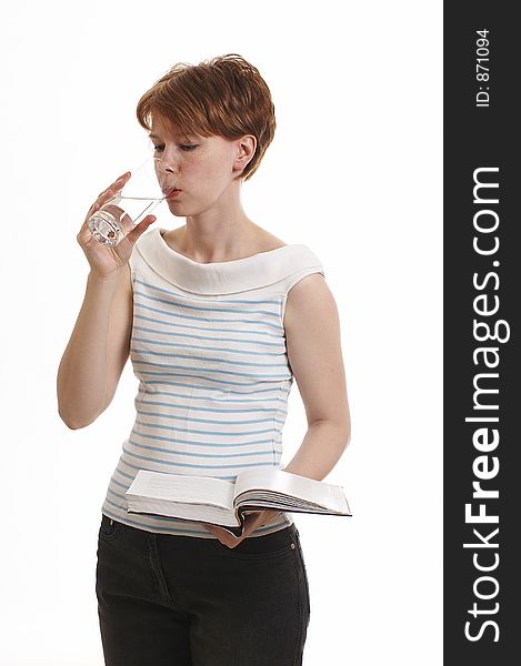 Girl holding the book and drinking water