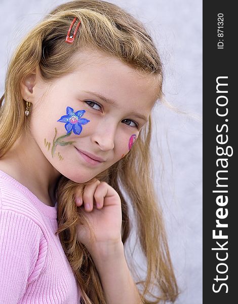 Beautiful young girl with a flower and butterfl drawing on her cheek. Beautiful young girl with a flower and butterfl drawing on her cheek