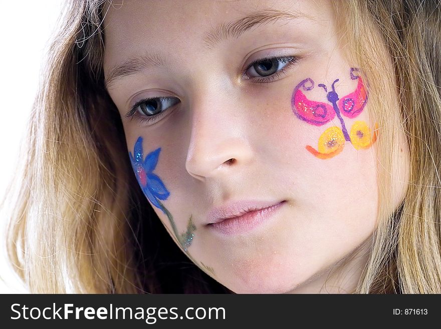 Beautiful young girl with a flower and butterfl drawing on her cheek. Beautiful young girl with a flower and butterfl drawing on her cheek