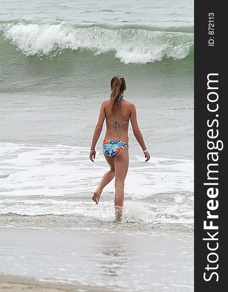 Teenage girl wading in the ocean. Teenage girl wading in the ocean